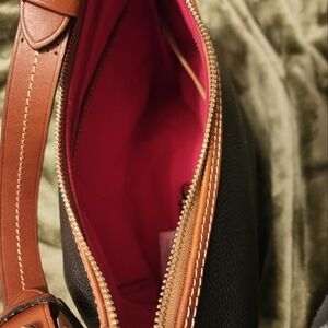 Dooney and Bourke Hobo Pebble grained leather purse. Black with Brown trim